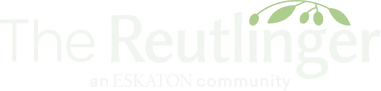 Faint green text reads The Reutlinger with a branch and leaves above the word on a light background.